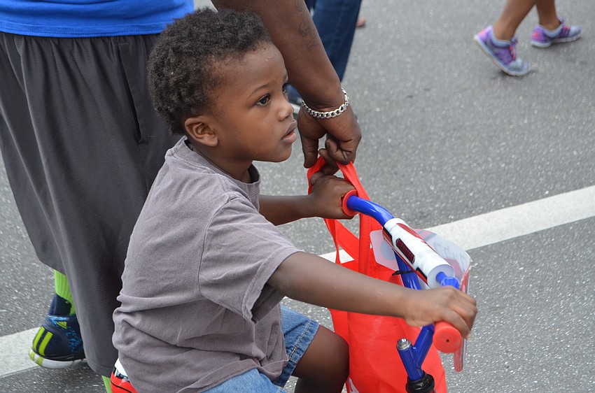 Maddox Richardson, 3, rides his bike down Dr. Martin Luther King Way.