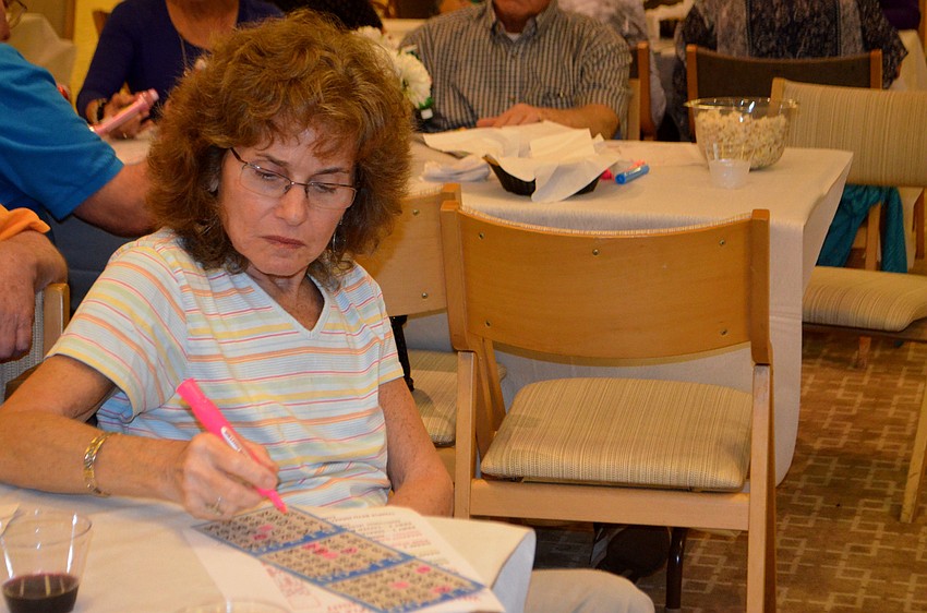 Arlene Yolles marks her card during Temple Beth Israel’s bingo night.