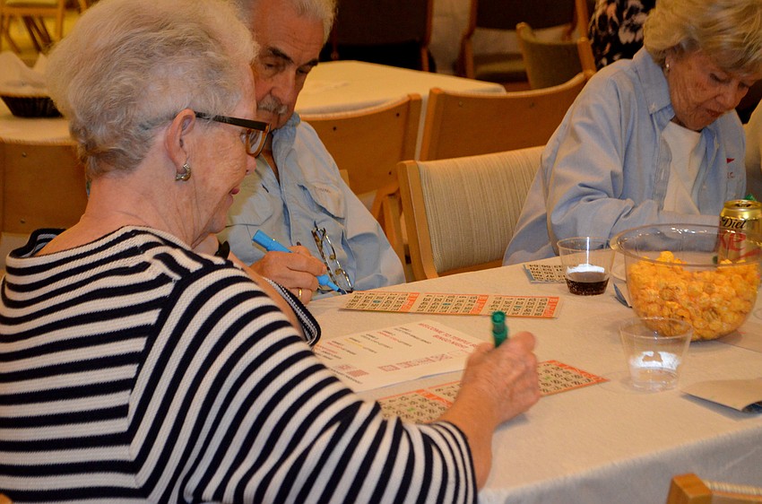 Susie Murphy marks her card during Temple Beth Israel’s bingo night. Players played five games with three cards throughout the night.