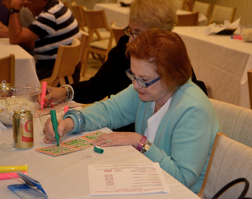Barbara Horowitz marks her card during the second game of the night. Players played five games with three cards during the event.