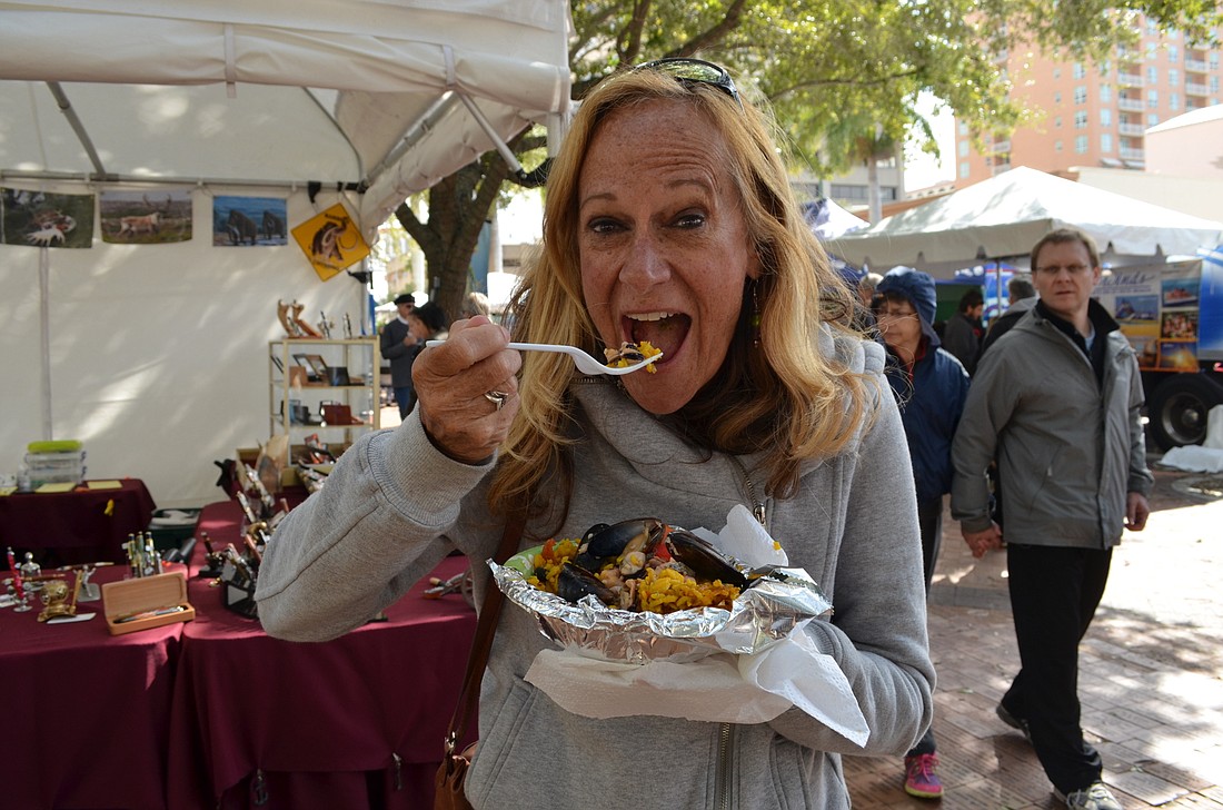 Kathy Whyte takes a bit out of her seafood paella at the inaugural Sarasota Seafood and Music Festival in 2016.
