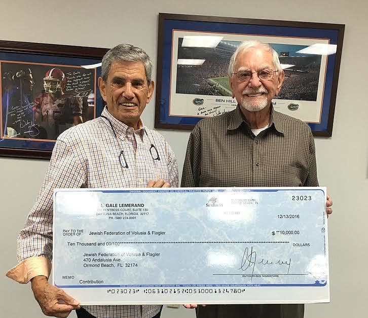 Gale Lemerand, presenting his $10,000 check to Marvin Miller, President of the Jewish Federation (Courtesy photo).