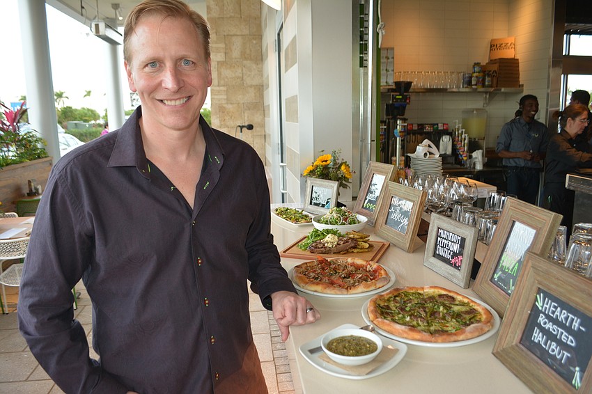 Chris Morris, the California Pizza Kitchen president, shows off a selection of offerings at a Sneak Peak event.