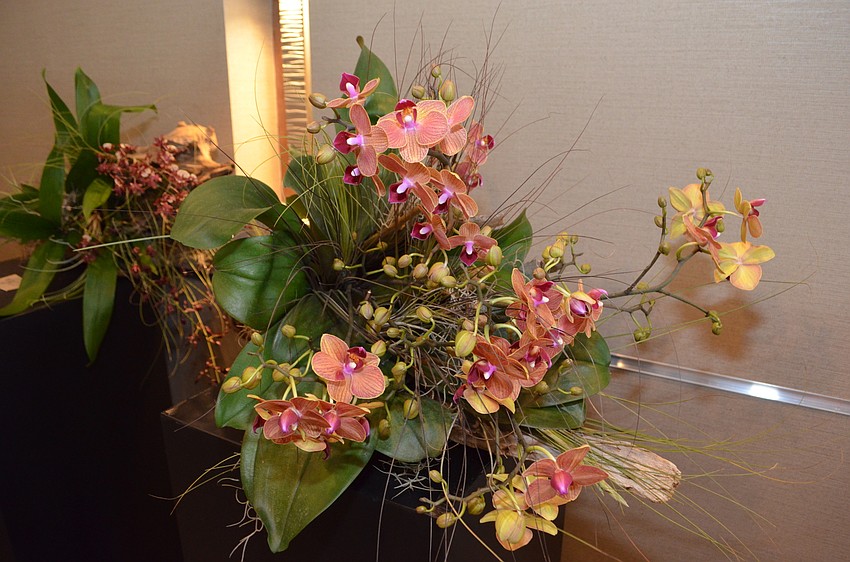 Guests bid on several orchids during lunch.