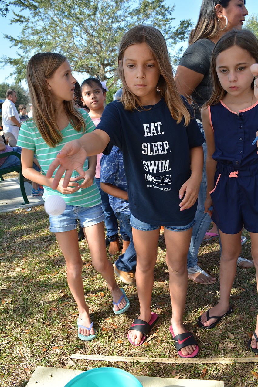 Six-year-old Anna Vatter, center, threw the ball in four of six buckets.