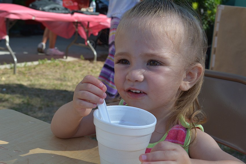 Kaliah McManus, 1, slurps on a melted crushed ice snack.