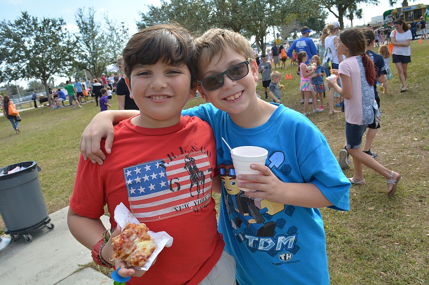 Gabriel Naguib and Ethan Schoenfeld, both 8, wander around with snacks and check out all their game options.