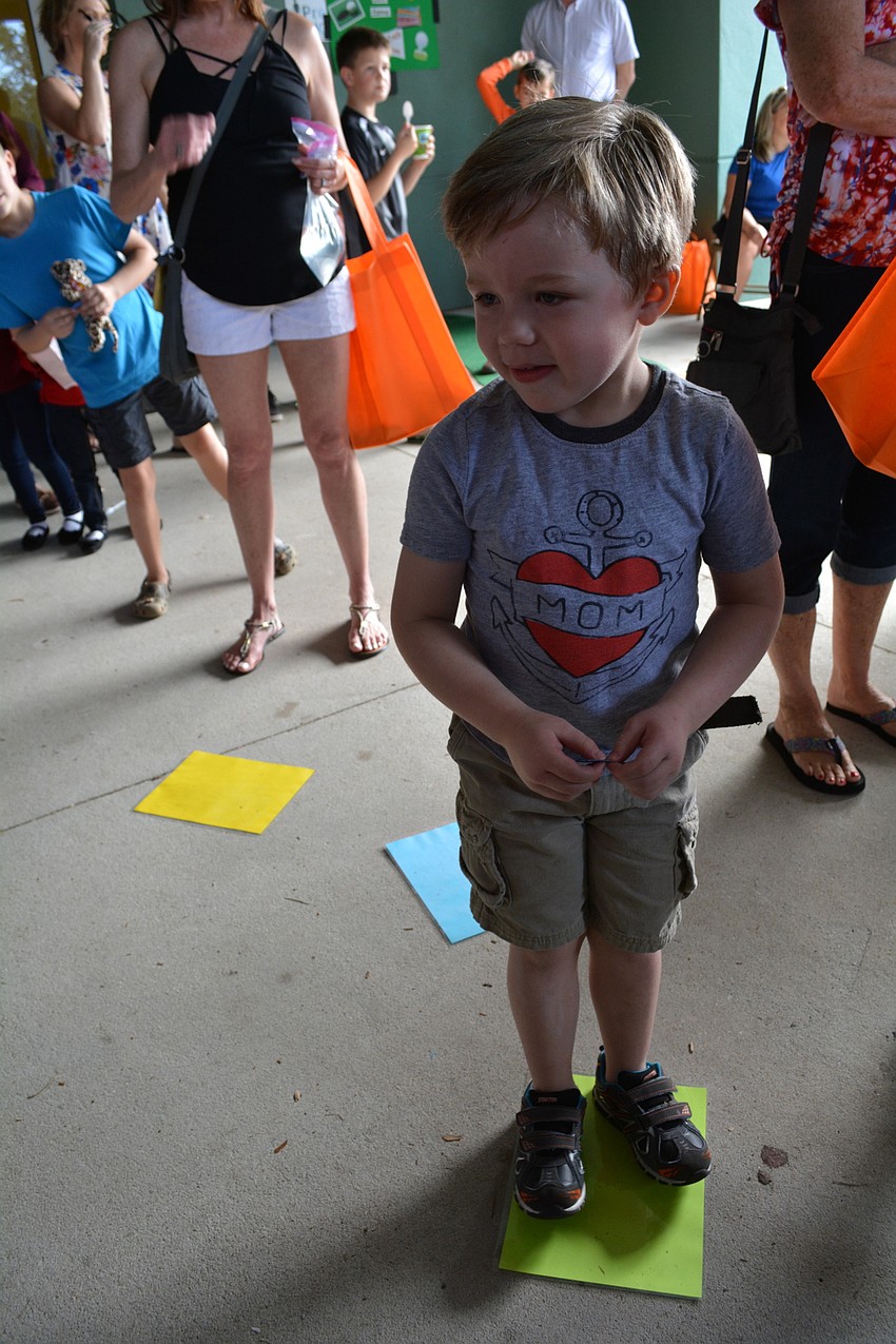 Reid Beddoe, 4, is excited to try a variation of the cake walk game.