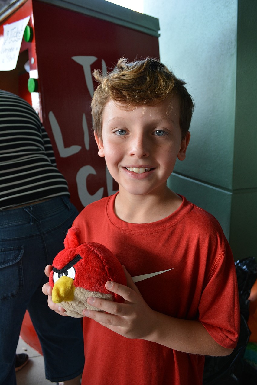 Payton Bledsoe, 8, was pleased with the Angry Bird stuffed animal he won at the 