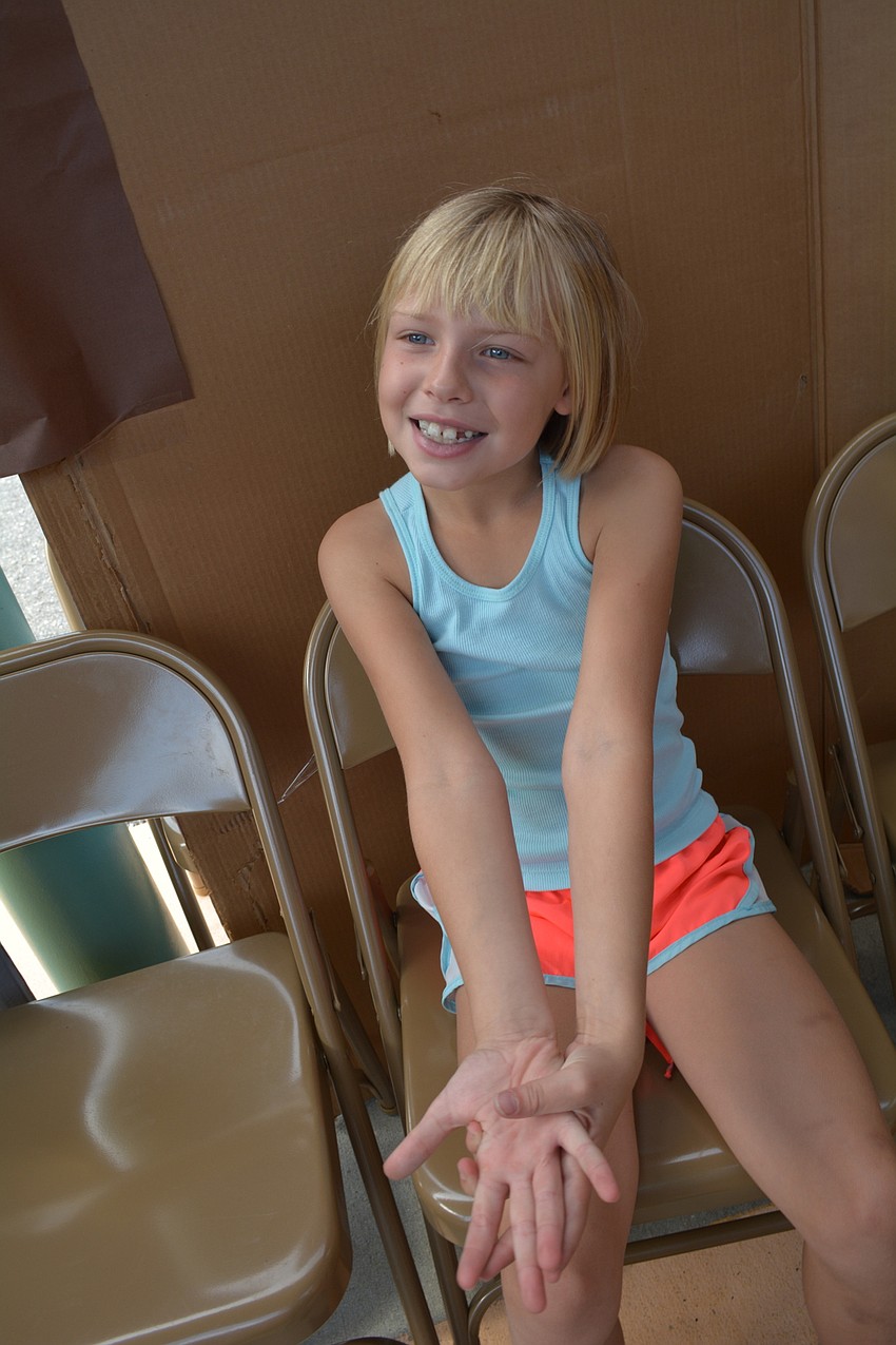 Payton Gee, 8, pleads for a friend passing by to give up some tickets and free her from 