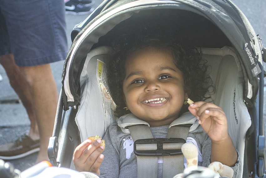 Chloe Paris eats a french fry during the Sarasota Seafood and Music Festival.