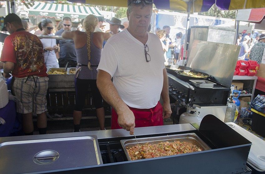 Bob Greene mixes seafood gumbo in the Captain Bob tent at the Sarasota Seafood and Music Festival.