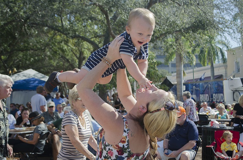 Katrina Van Norman lifts Jackson Van Norman into the air.
