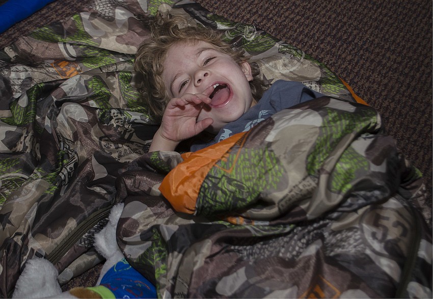 Jett Segal lays in his sleeping bag before the movie starts.