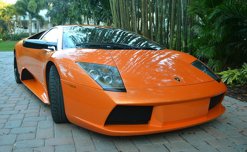 An orange lamborghini was on display for guests to admire.