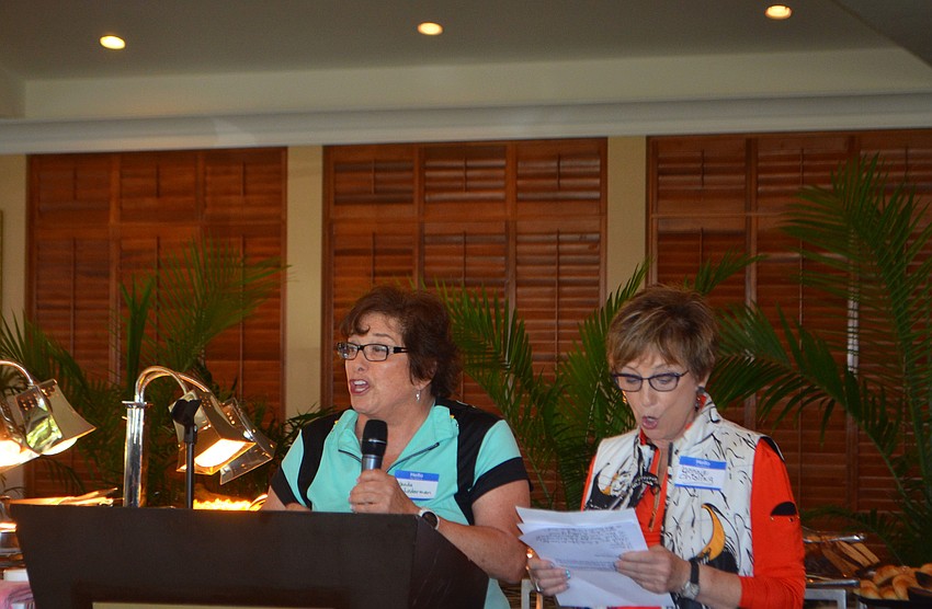 Brenda Lederman and Bonnie Chisling sing a song that Lederman wrote to the new members.