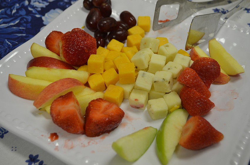Attendees enjoyed assorted fruits and cheeses with their wine.