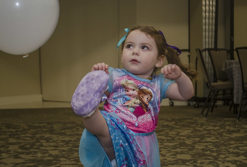 Sasha Leopold kicks a balloon before the showing of Disney'   s Frozen.