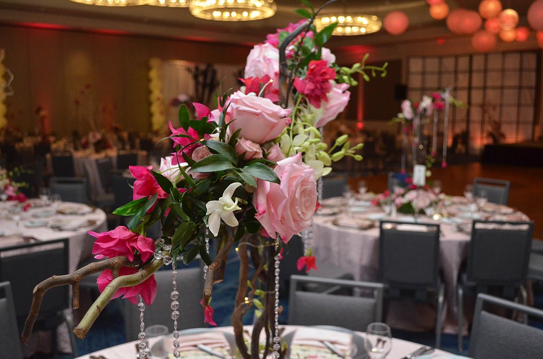 The centerpieces at the Sarasota Opera Gala were created by Becky Creighton of Flowers by Fudgie, and because no cherry blossoms could be found, they were replaced with pink roses, pink bougainvillea and orchids.