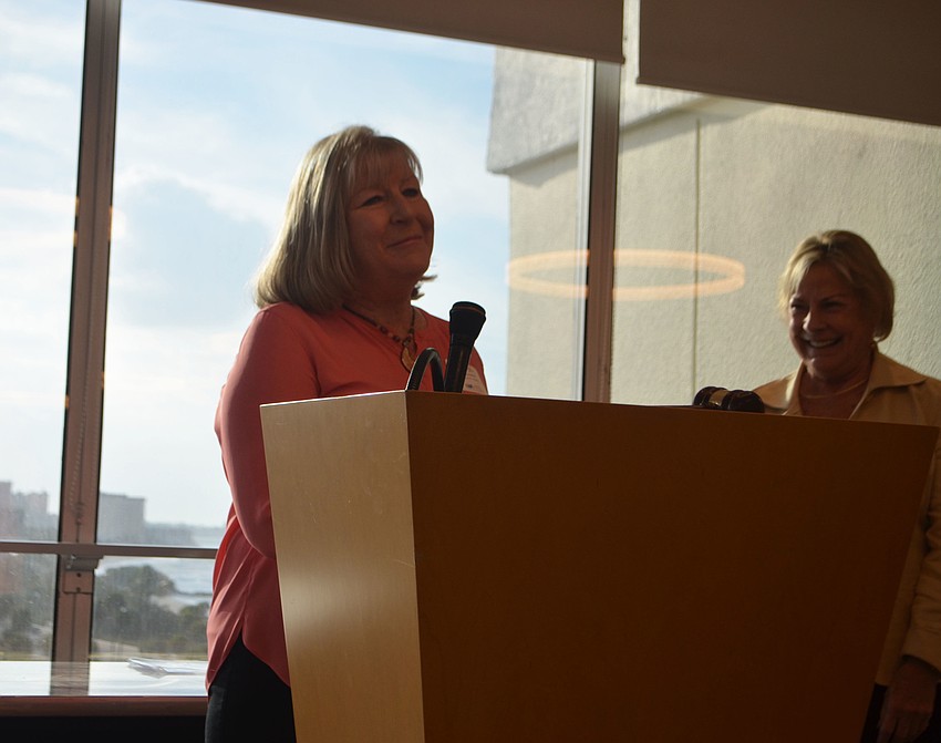 Carol Erker speaks to the crowd after accepting the “Ed Moran Memorial Award” on behalf of the Longboat Key Rotary Club.