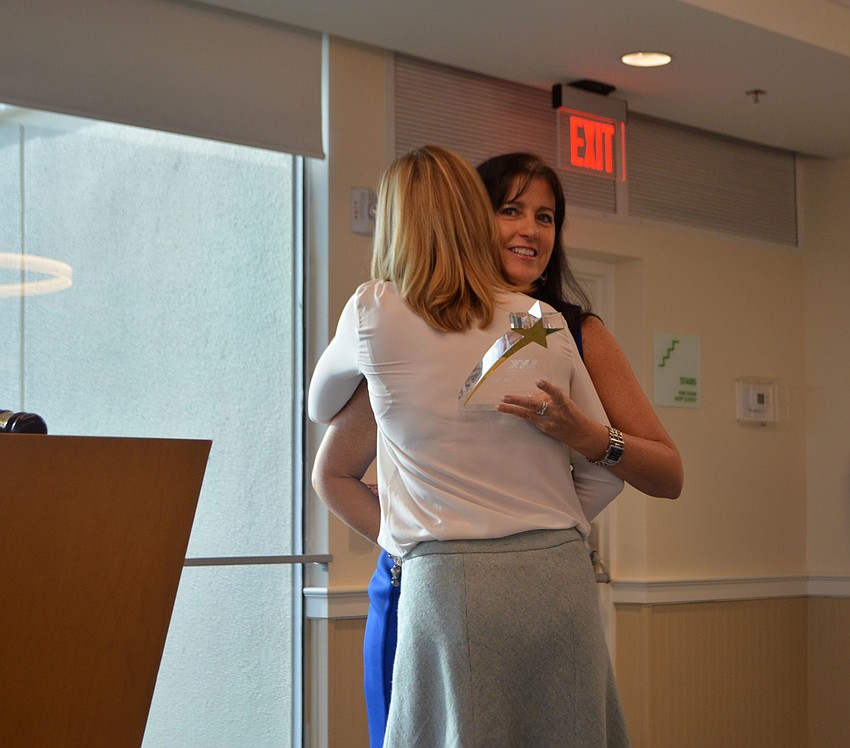 Sherri Mills hugs Tammy Halsted as she accepts the “Member of the Year” award.
