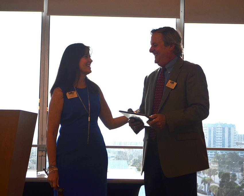 Tammy Halsted laughs as she passes the gavel to the 2017 Chamber Chairman Michael Doll.