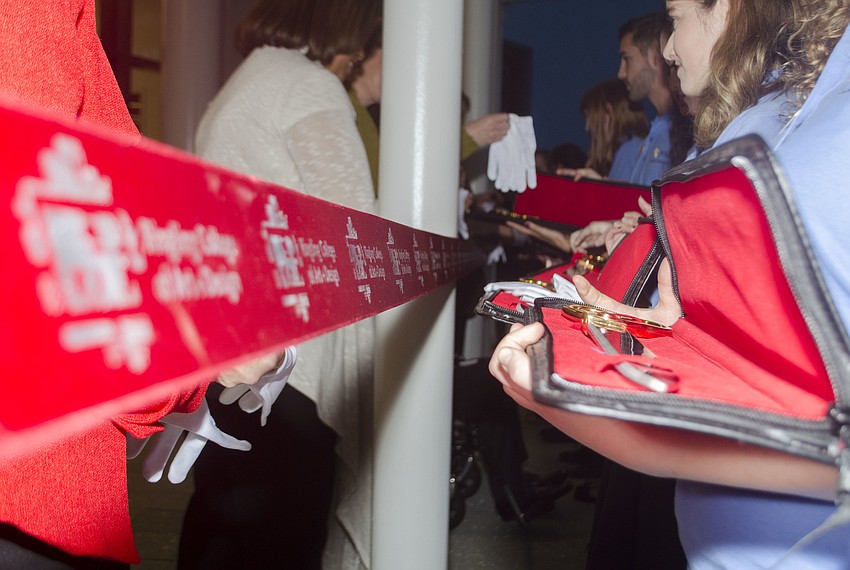 Trustees, board members, staff and patrons of Ringling College of Art and Design lined up behind the ribbon to receive their scissors for the ribbon cutting.