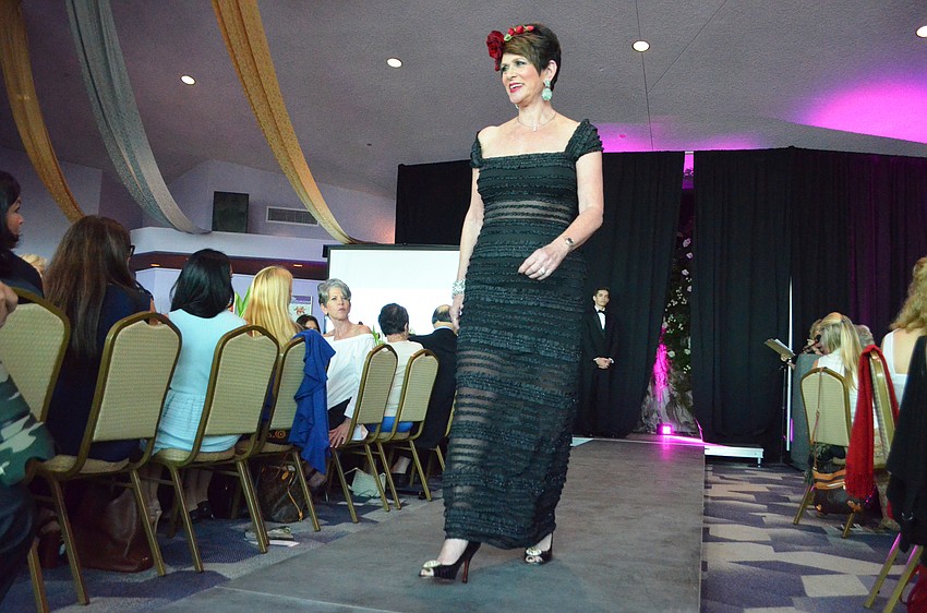 Wendy Feinstein struts the runway in one of her own dresses that she donated to Selah Vie Boutique.