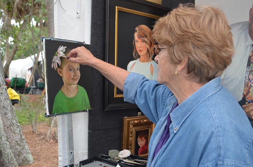 Lynda Kodwyck paints a portrait of her granddaughter. Kodwyck specializes in original fine art portraits and seascapes.