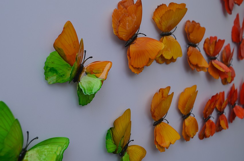Butterfly sculpture by Ancizar Marin hung on boards in St. Armands Circle Park. Marin was one of more than 175 artists who displayed work at St. Armands Circle over the weekend.