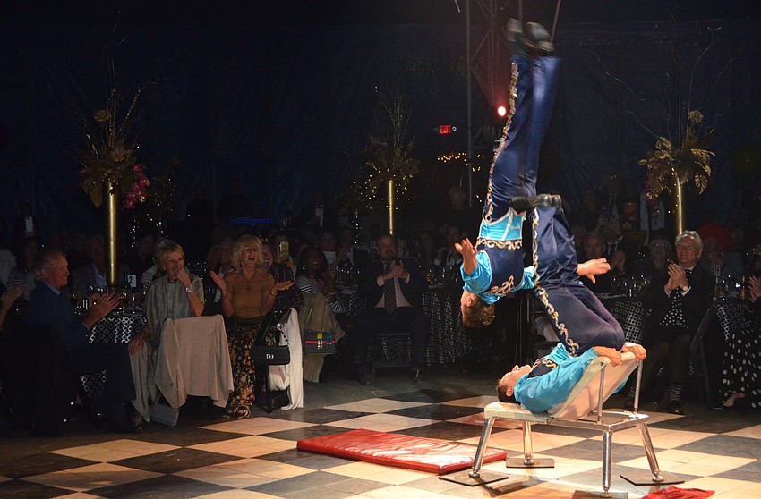 Adrian Poema Sr. juggles  Adrian Poema Jr. with his feet.