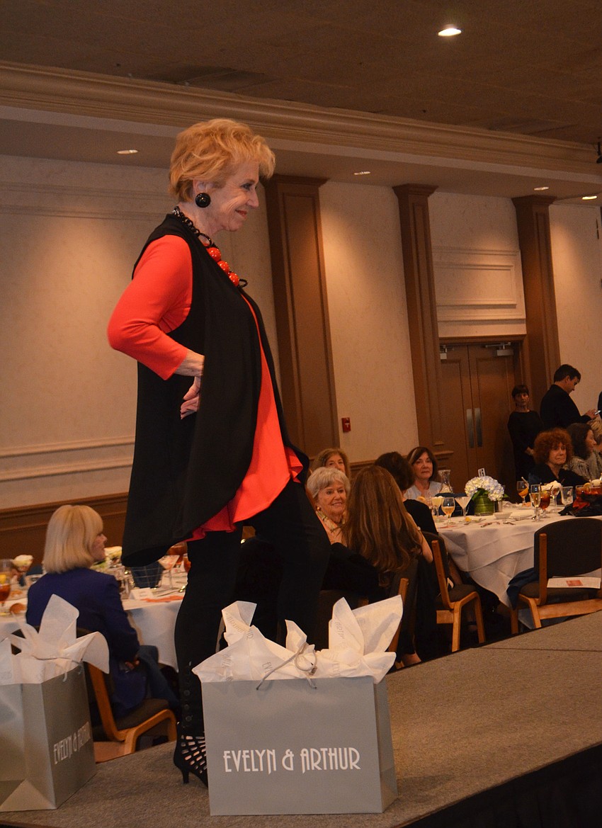 Molly Schechter smiles as she walks the runway during Beth Israel Women’s fashion show.