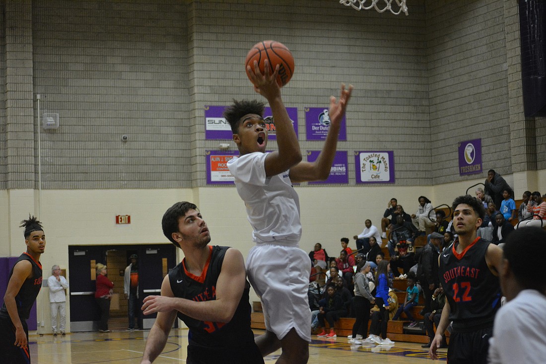 Johnnie Williams IV drives the lane for a layup against Southeast.