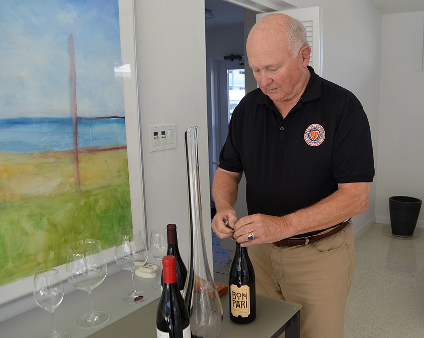 George Muller opens a bottle of Bon Pari pinot noir.