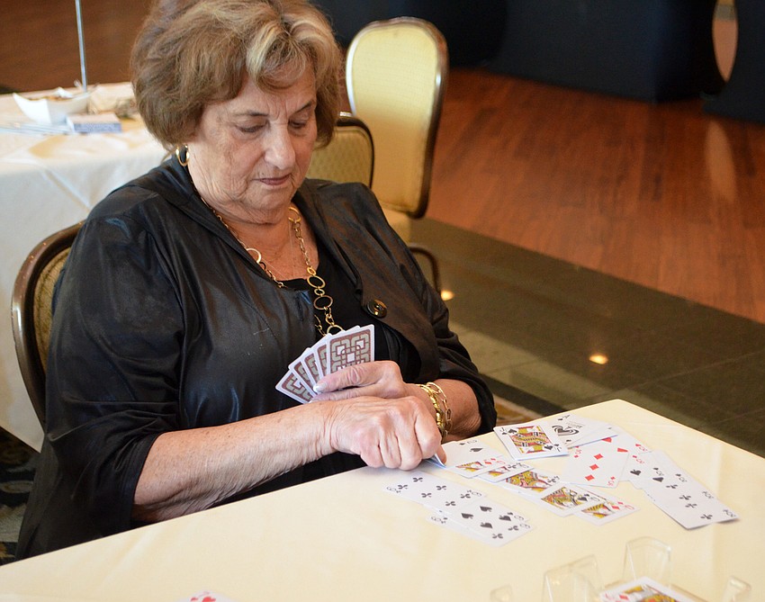 Jackie Nusbaum takes a turn during a game of canasta during Go for the Cure Games day. All proceeds from the event benefit Breast Health Sarasota, Inc.