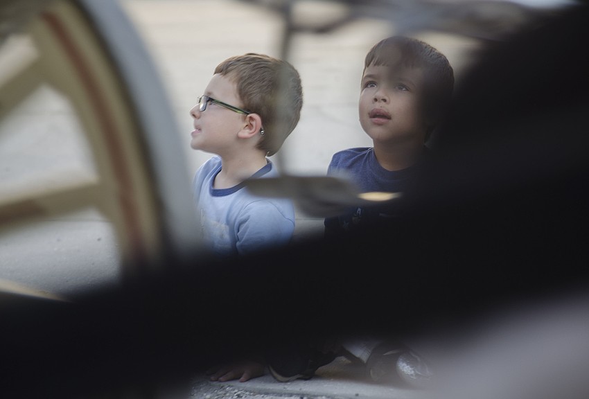 Austin and Sean Daley watch Budweiser Clydesdale wagon as it makes it way to Ocean Boulevard.