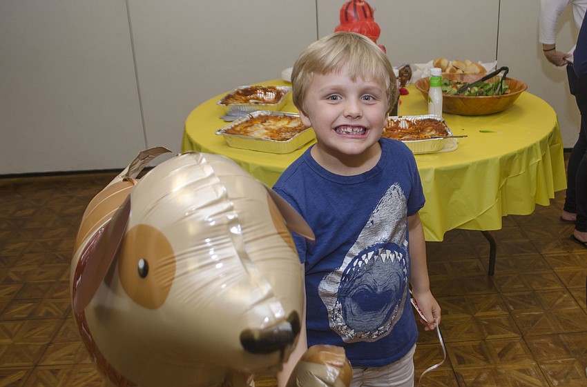 Austin Bobb plays with a balloon before the movie