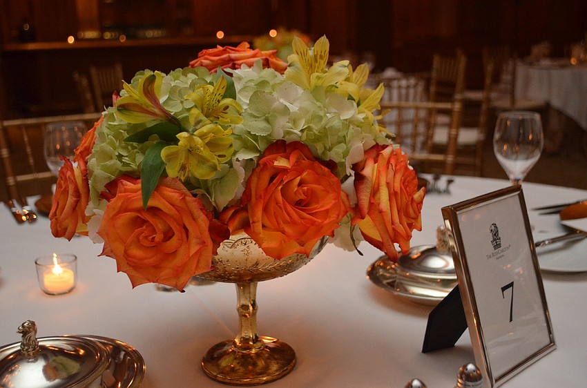 Each table was simply decorated with gold settings and flowers in the center.