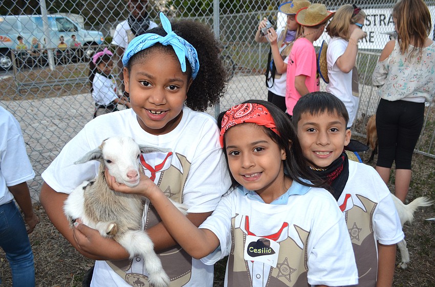 Ariana A., Ayden M. and Cesilla P. get to know a baby goat up close and personal.