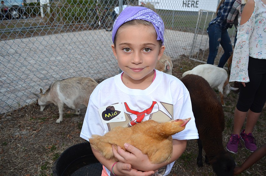 Mia H. holds her new chicken pal.