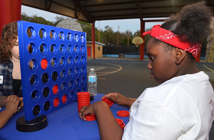 Zykeria S. focuses on her next move during a game of checkers.