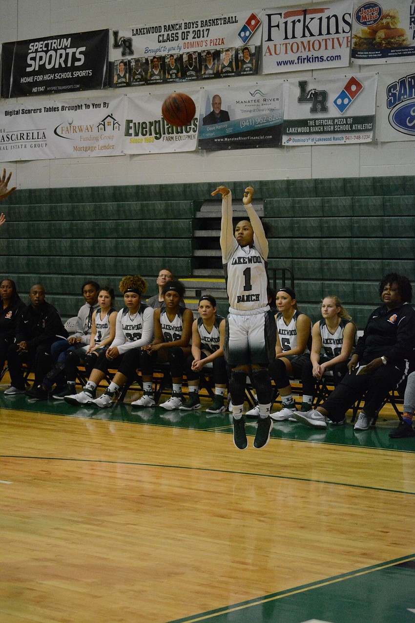 Junior Kayla Bell shoots a three-pointer.