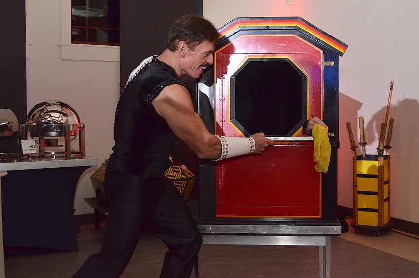 Performer Rafael Palacios “saws” his assistant, Erika Cain, inside a box.