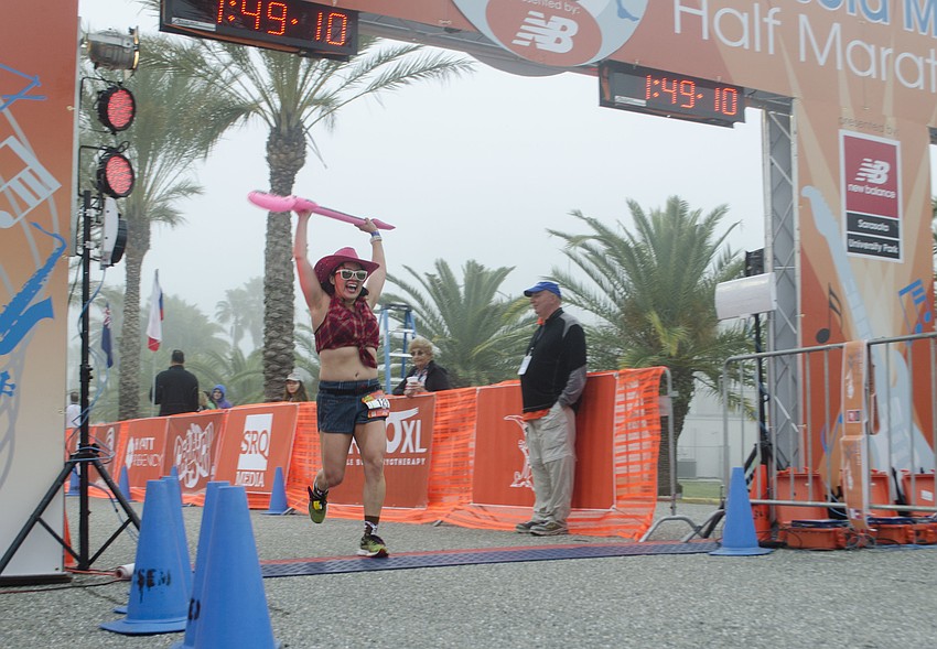 Krissy Murphy crosses the finish line at the Sarasota Music Half Marathon.