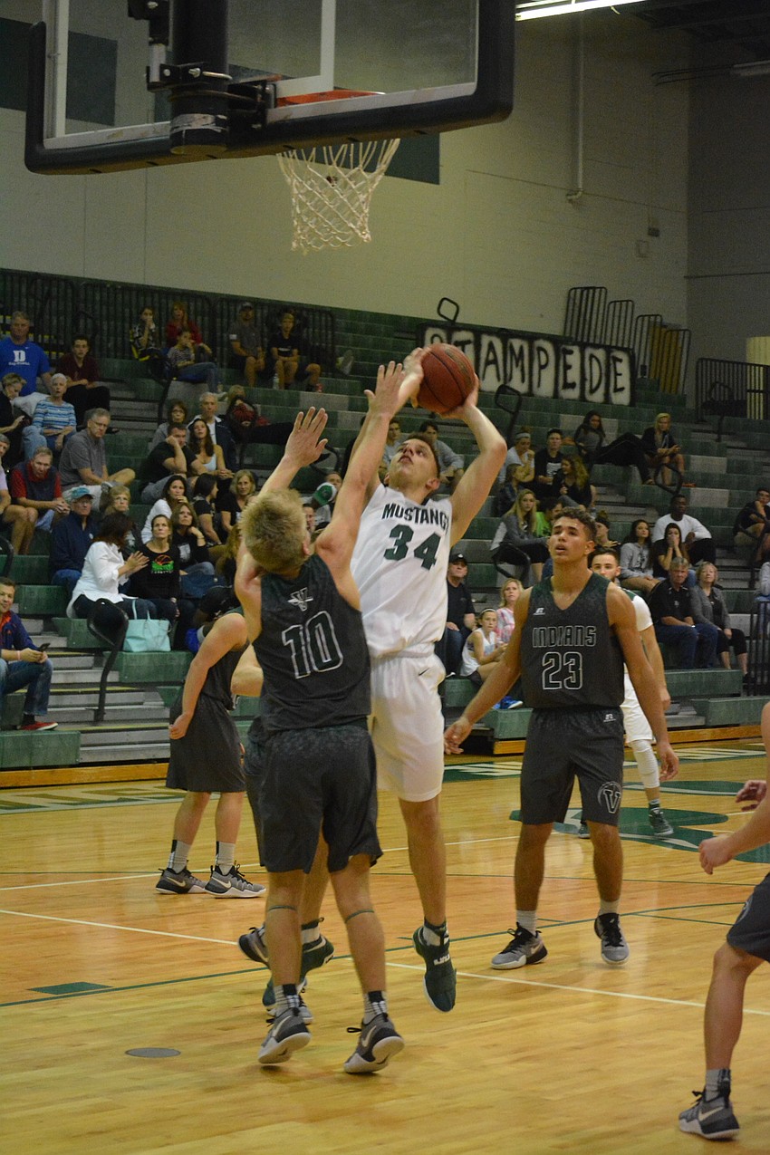 Junior Jack Kelley adjusts for a layup.