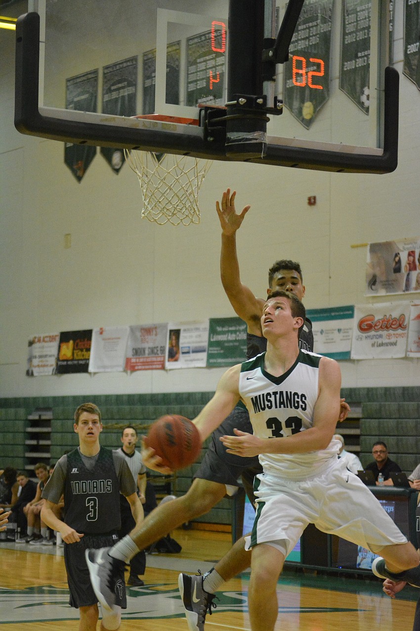 Senior Justin Muscara goes under the basket for a shot.