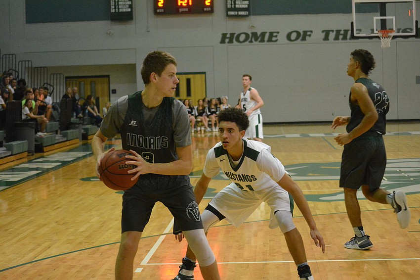 Junior Evan Spiller closely guards a Venice player.