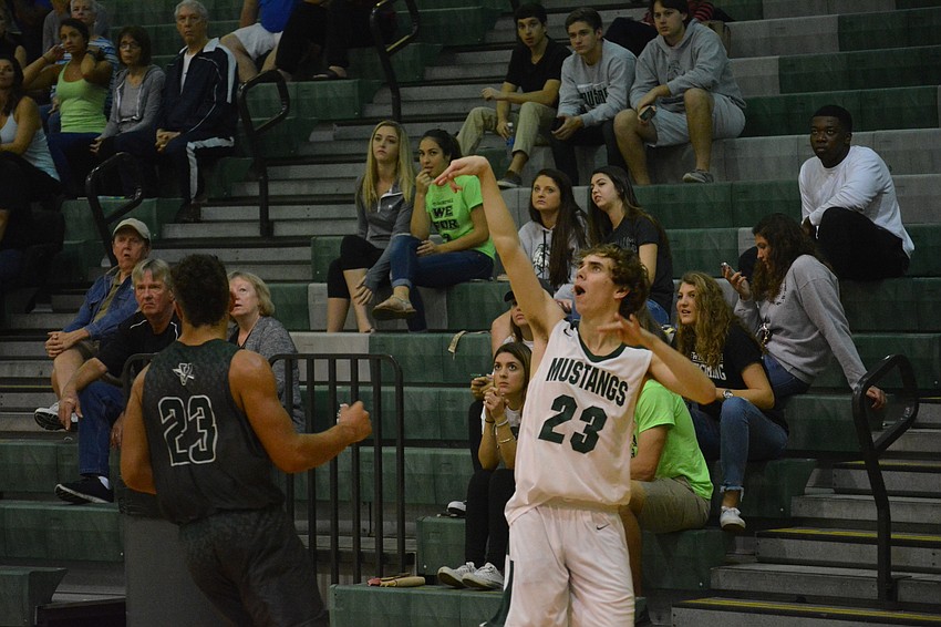 Senior Brock Sisson holds his release on a three-point shot.