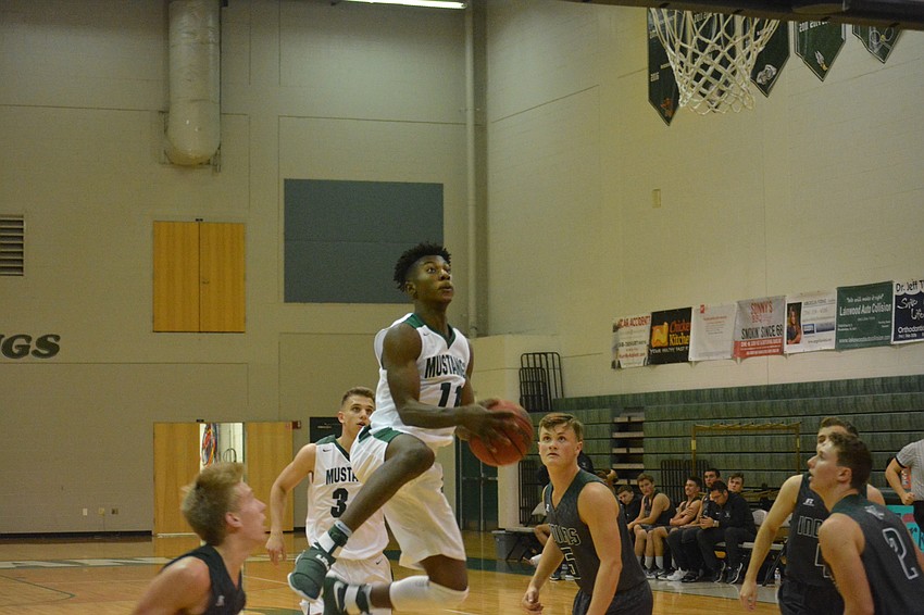 Senior Blauvelt Georges leaps in the air for a shot.