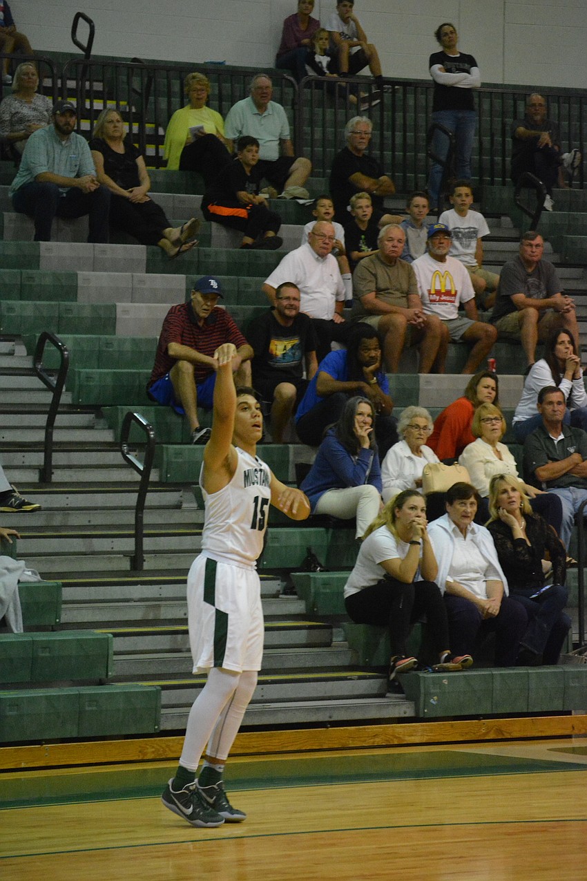 Senior Kodey Elliot watches his own three-pointer.